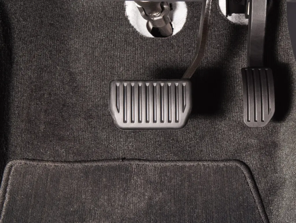 Close-up of gas and brake pedal. 