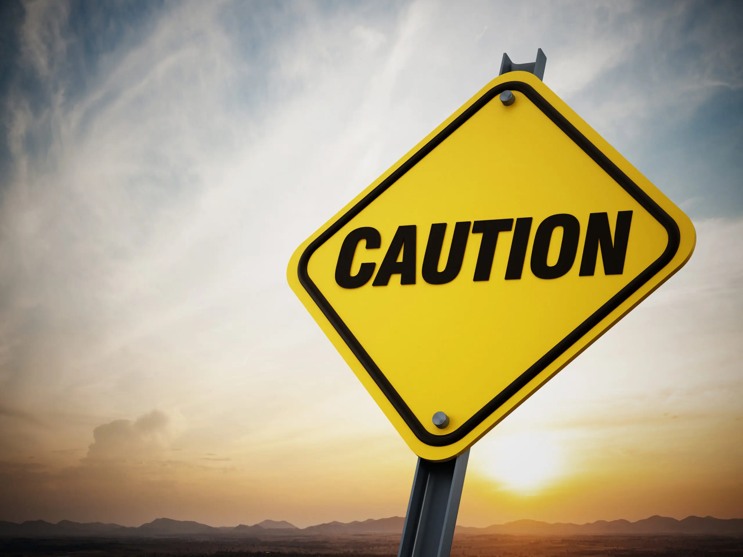 Street sign that reads "caution."