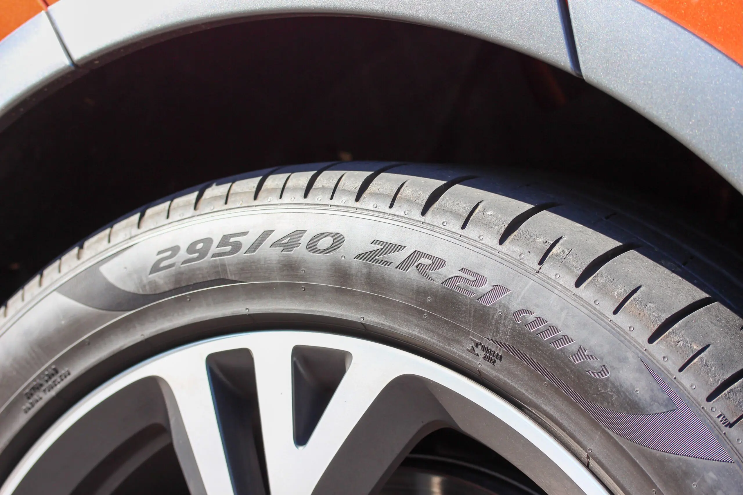 Close up of a tire sized 295/40 ZR21, showcasing where to see the tire speed rating.