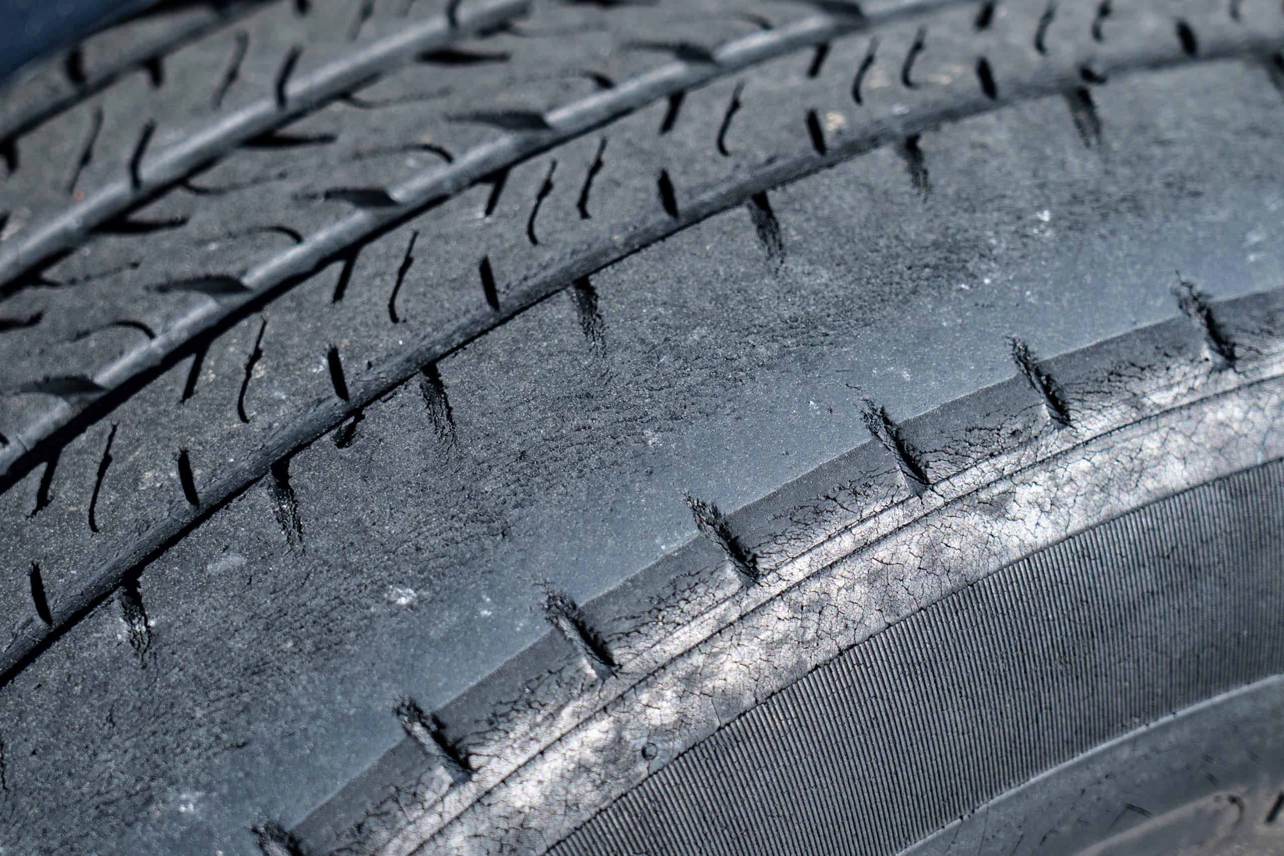 tire wear patterns closeup of a dangerously worn tire tread