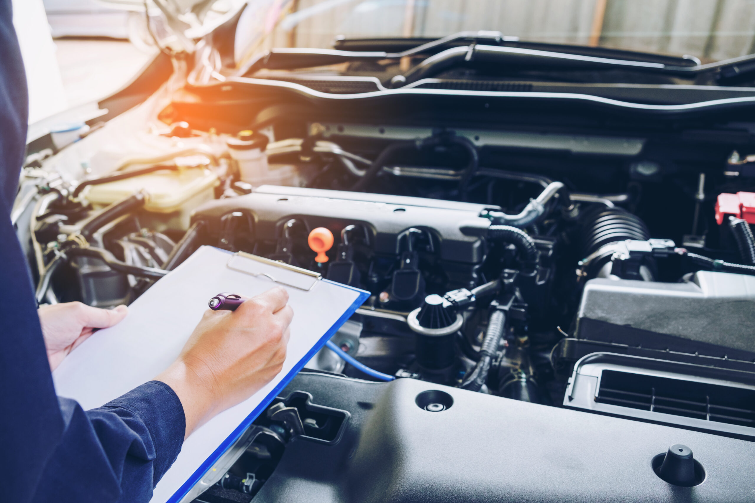 Mechanic conducting a safety inspection on car.