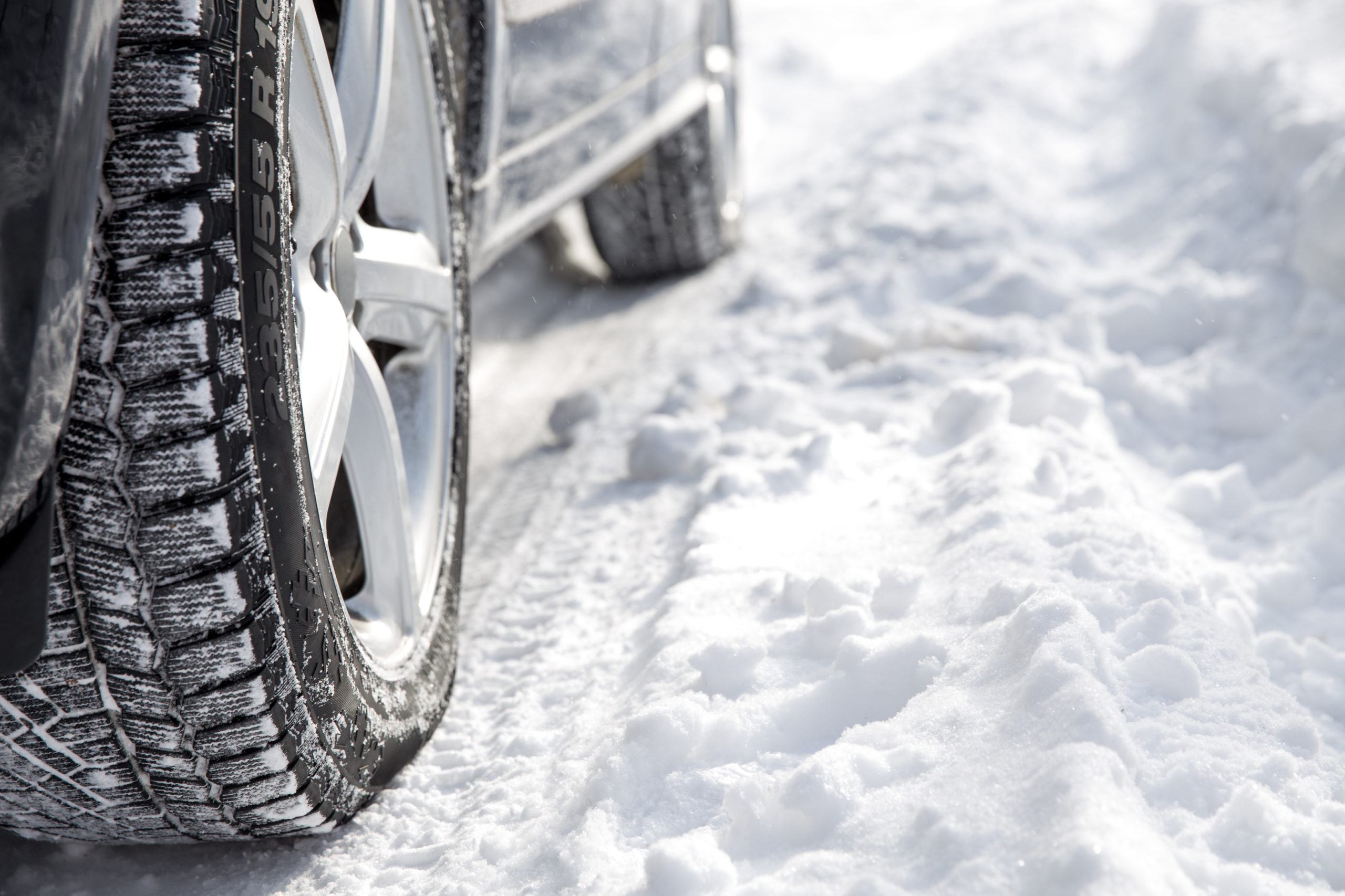 Driving SUV car in winter on forest road with much snow