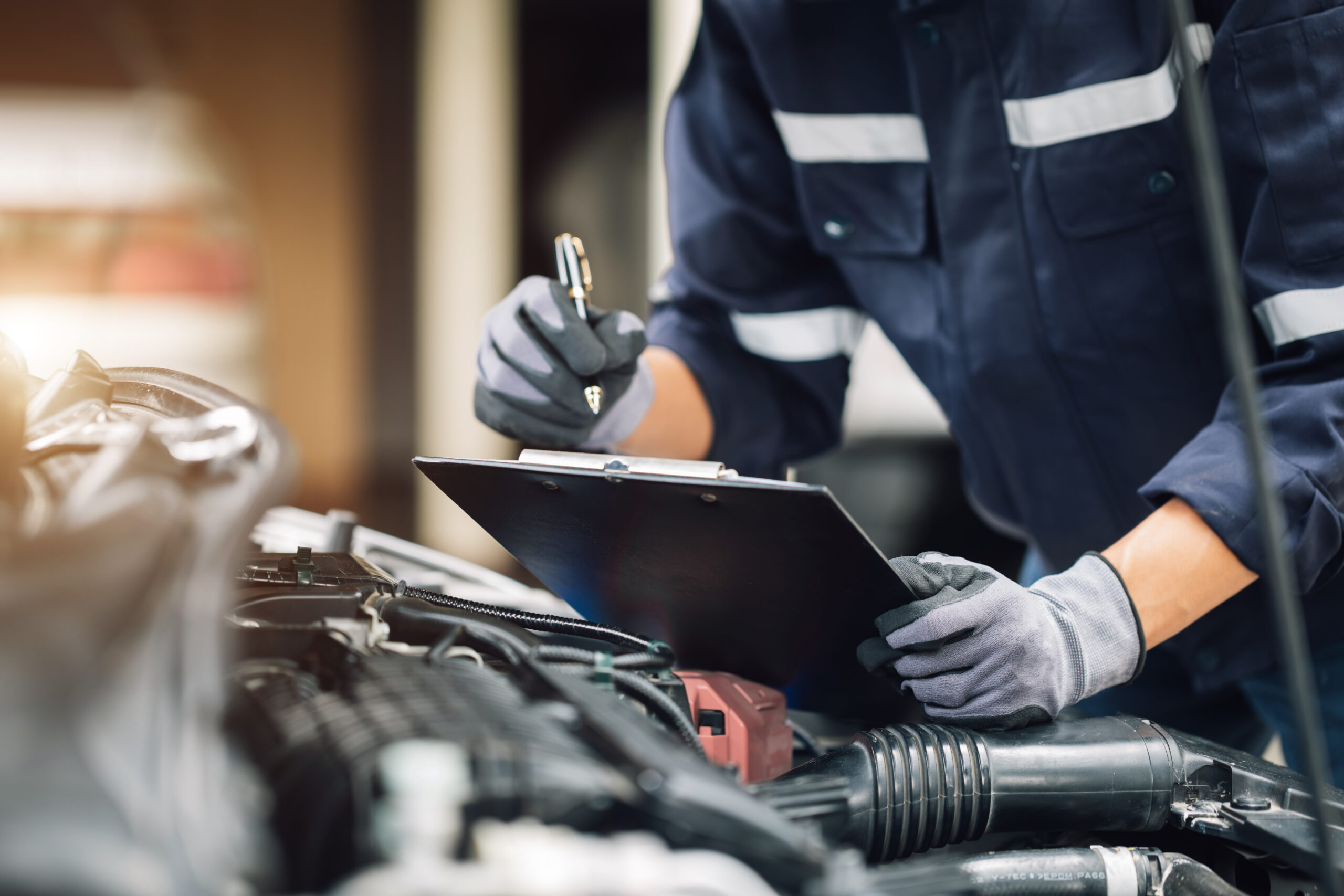 Mechanic inspecting car engine.