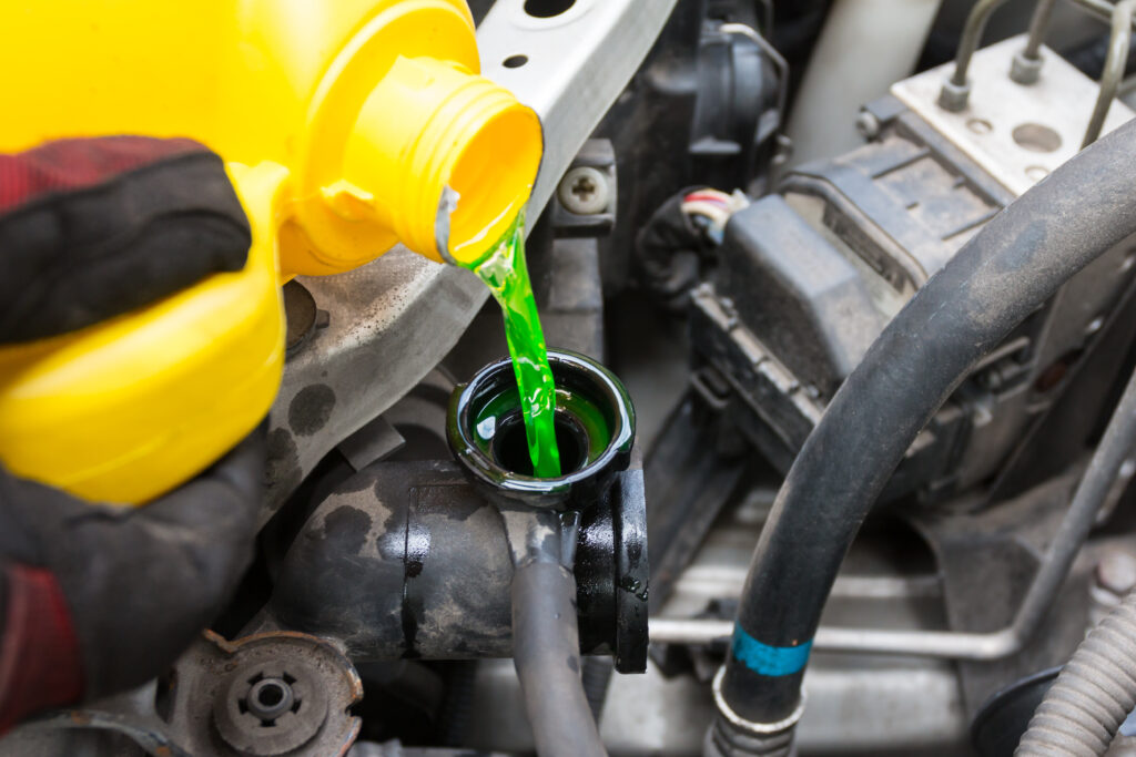 Close-up of refilling engine fluid. 