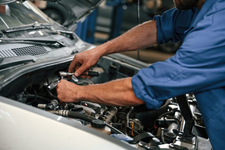 Close-up of mechanic working on car.