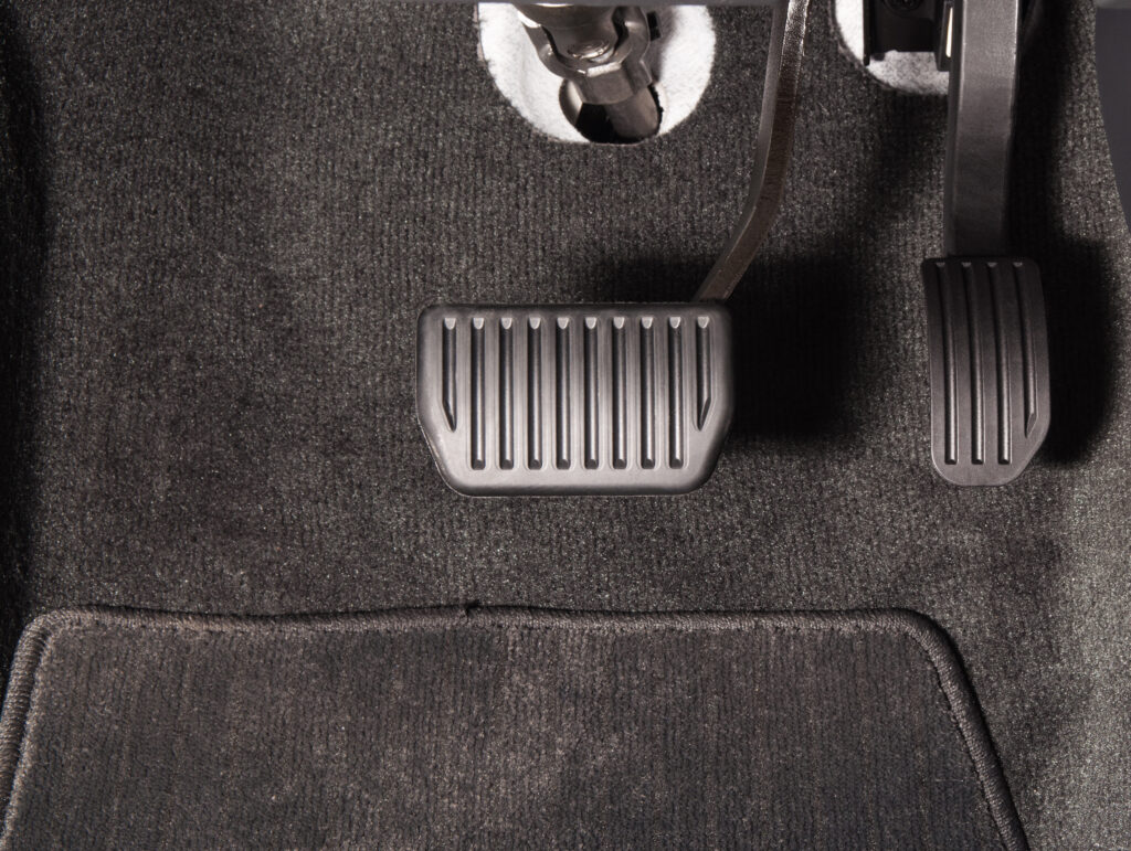 Close-up of gas and brake pedal. 
