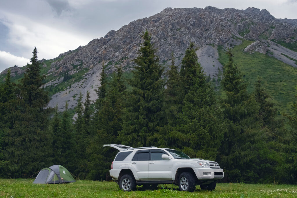 SUV with mountains in background. 
