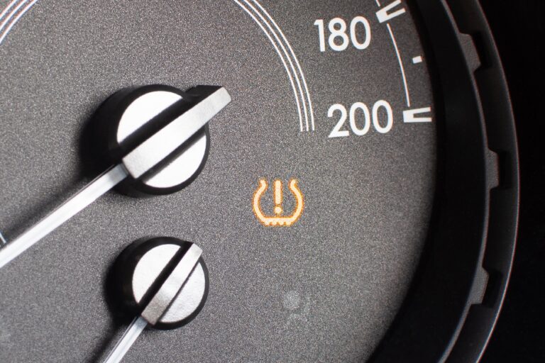 Tire pressure warning light on car dashboard as triggered by the TPMS sensor.