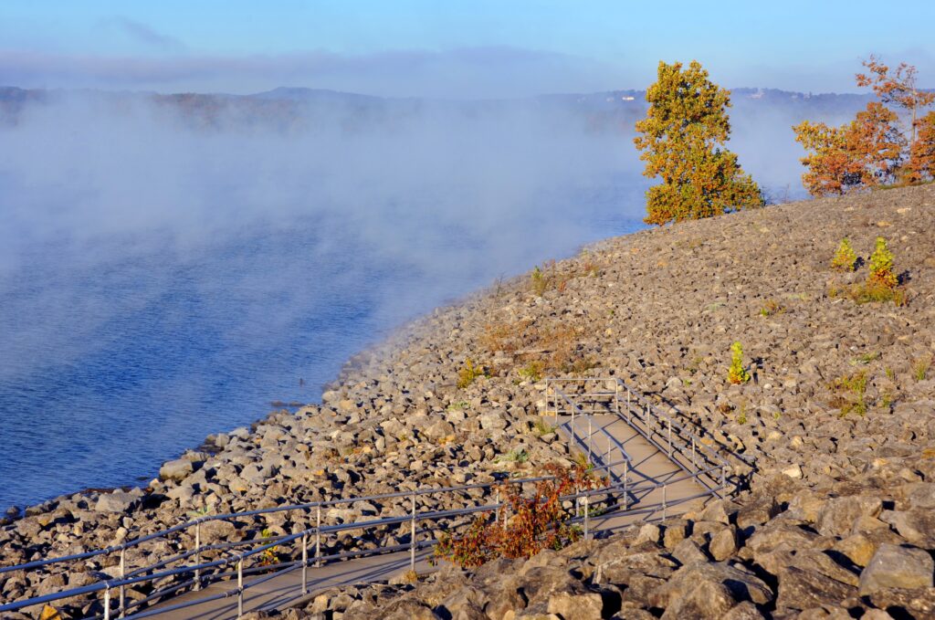 Penninsula Observation Loop on Table Rock Lake in Branson, Missouri, has ramped observation points to look at the beautiful lake. Early light illumines misty lake.