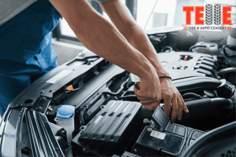 Technician performing car battery testing at Telle Tire & Auto Centers