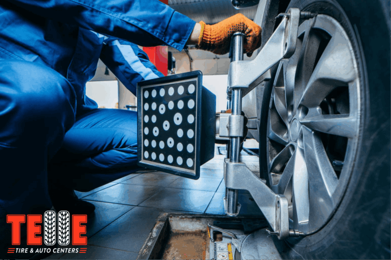 Technician performing wheel alignment on a vehicle at Telle Tire & Auto Centers in St. Louis