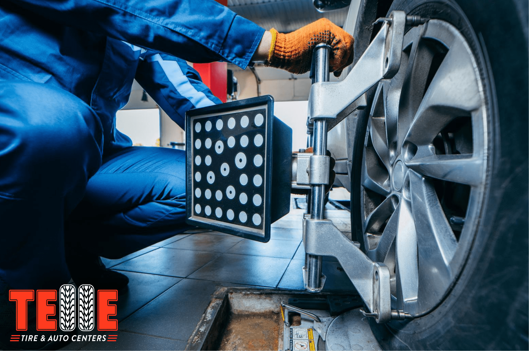 Technician performing wheel alignment on a vehicle at Telle Tire & Auto Centers in St. Louis